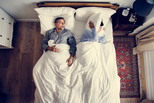 Man with sleep apnea disorder and woman trying to sleep - NSW CPAP
